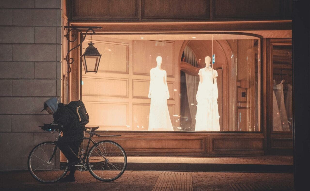 Creative Storefront Strategies to Boost Customer Traffic Man on a Bicycle in Front of the Window of a Wedding Dress Shop
